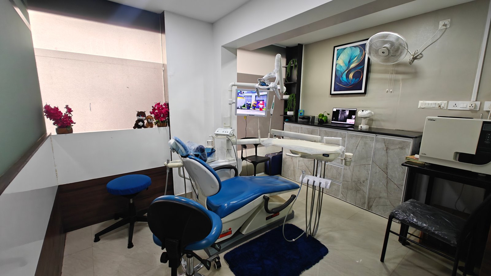 A dentist speaking with a patient during a consultation